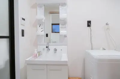 a white bathroom with a sink and a mirror at ISSHUKU Noma \u5317\u65b0\u5bbf -101 Multiple Beds Room 4-6 Guests in Tokyo