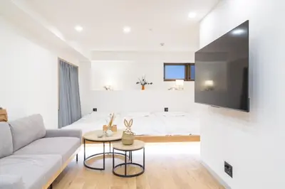 a living room with a couch and a bed at ISSHUKU Noma \u5317\u65b0\u5bbf -101 Multiple Beds Room 4-6 Guests in Tokyo