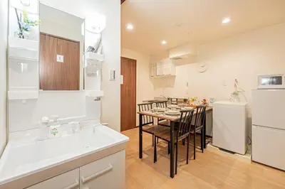 a kitchen and dining room with a table and a refrigerator at Ginza Stay Tsukishima Station 1-minute walk, Ginza, Shinjuku, Tsukiji Market tram direct, supermarket, next to the canal, Tokyo Bay stroll in Tokyo