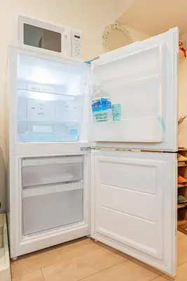 a white refrigerator with its door open and a microwave at Ginza Stay Tsukishima Station 1-minute walk, Ginza, Shinjuku, Tsukiji Market tram direct, supermarket, next to the canal, Tokyo Bay stroll in Tokyo