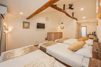 two beds in a room with white walls at Ginza Stay Tsukishima Station 1-minute walk, Ginza, Shinjuku, Tsukiji Market tram direct, supermarket, next to the canal, Tokyo Bay stroll in Tokyo