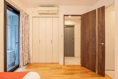 a bedroom with a door leading to a bathroom at Skytree Stay Home, a 4-minute walk from Oshiage Station, a private house with an elevator in Tokyo