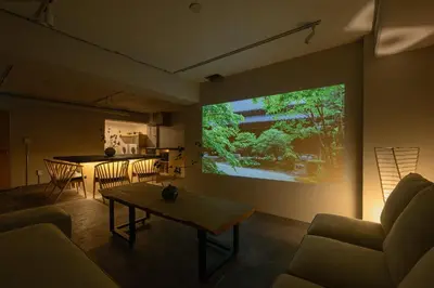 a living room with a table and a large screen at Zen Premium Suite Newly Renovated Luxury Home 2King Beds Near Shinjuku in Tokyo