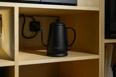 a black tea kettle on a shelf in a cabinet at Zen Premium Suite Newly Renovated Luxury Home 2King Beds Near Shinjuku in Tokyo