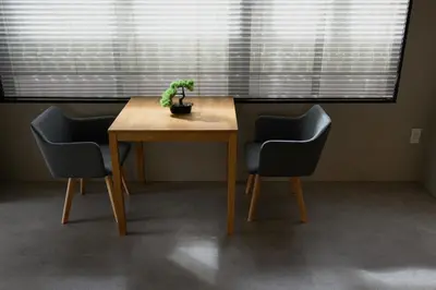 a table with two chairs and a potted plant on it at Zen Premium Suite Newly Renovated Luxury Home 2King Beds Near Shinjuku in Tokyo