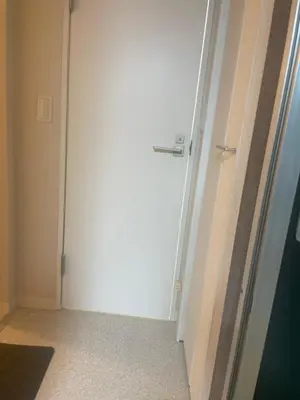 a white door in a room with a door at Aila apartment in Tokyo