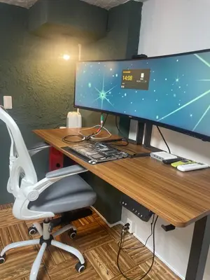 a desk with a computer monitor and a chair at Aila apartment in Tokyo