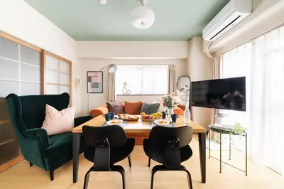 a living room with a table and chairs at Felizstay 907 in Tokyo