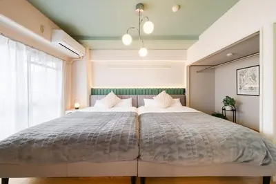a bedroom with a large bed with white pillows at Felizstay 907 in Tokyo