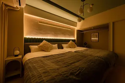 a bedroom with a large bed with lights on it at Felizstay 907 in Tokyo