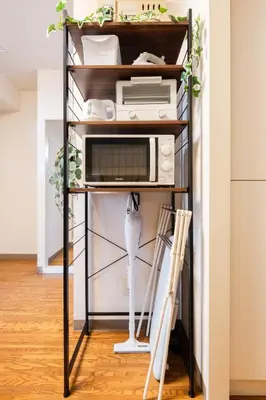 a shelf with a microwave and a toaster oven at Felizstay 907 in Tokyo