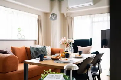 a living room with a table with food on it at Felizstay 907 in Tokyo