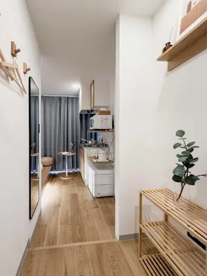 a living room with white walls and a wooden floor at ISSHUKU Noma \u5317\u65b0\u5bbfI -201 Triple Room in Tokyo