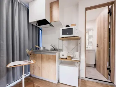 a small kitchen with a sink and a microwave at ISSHUKU Noma \u5317\u65b0\u5bbfI -201 Triple Room in Tokyo