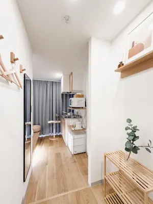 a living room with white walls and wooden floors at ISSHUKU Noma \u5317\u65b0\u5bbfI -201 Triple Room in Tokyo