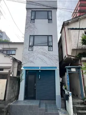 a building with a blue door on the side of it at \u5343\u675f3\u4e01\u76ee in Tokyo