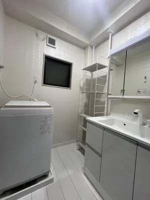 a white bathroom with a sink and a tv at \u5343\u675f3\u4e01\u76ee in Tokyo