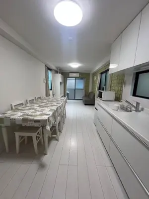 a large room with a table and a kitchen at \u5343\u675f3\u4e01\u76ee in Tokyo