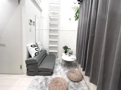 a living room with a chair and a table at 新宿Shin-Ōkubo Aeroland 2 in Tokyo