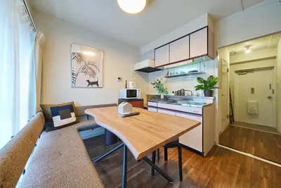a kitchen and living room with a wooden table at 23Maison-J\u5927\u4e45\u4fdd\u99c5\u8fd1 in Tokyo