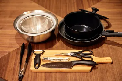 a table with a cutting board with a pan and utensils at Wa Modern stay Mukoujima Skytree Asakusa 10min in Tokyo
