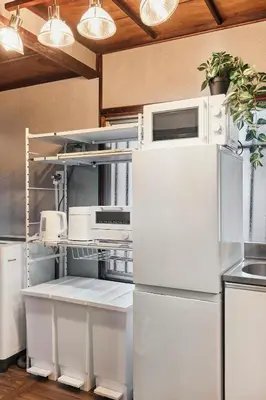 a kitchen with a refrigerator and a microwave at Wa Modern stay Mukoujima Skytree Asakusa 10min in Tokyo