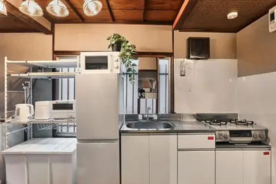 a kitchen with white cabinets and a sink at Wa Modern stay Mukoujima Skytree Asakusa 10min in Tokyo