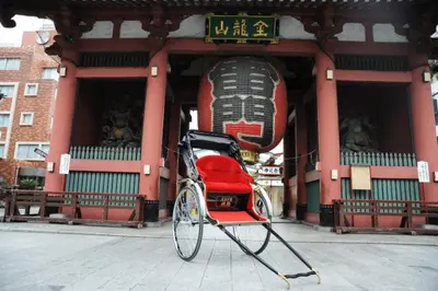 a red rickshaw parked in front of a building at Wa Modern stay Mukoujima Skytree Asakusa 10min in Tokyo