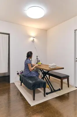 a woman sitting at a table in a room at HigashiNakano 3 rooms 1 bath with 2 different view in Tokyo