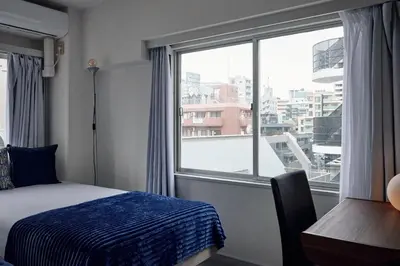 a bedroom with a bed and a large window at Tokyo Tower Roppongi walk 4 bed, Direct bus to Shibuya in Tokyo