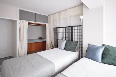 a bedroom with two beds and a window at Tokyo Tower Roppongi walk 4 bed, Direct bus to Shibuya in Tokyo