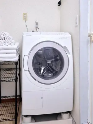 a white washing machine sitting in a room at Tokyo Tower Roppongi walk 4 bed, Direct bus to Shibuya in Tokyo