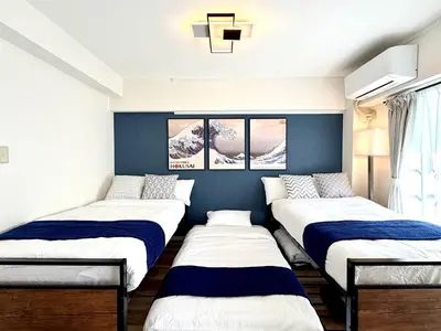 three beds in a room with blue walls at #403 Tokyo Ryogoku Hokusai Katsushika in Tokyo