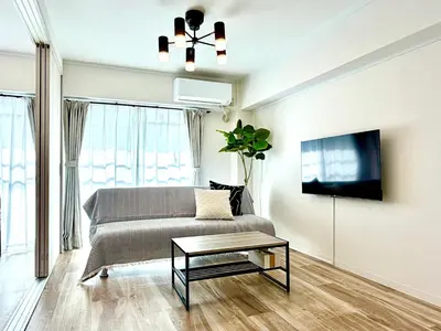 a living room with a couch and a tv at #403 Tokyo Ryogoku Hokusai Katsushika in Tokyo