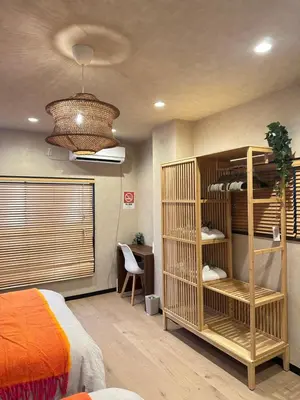a bedroom with a bed and a book shelf at KYOSAI-Asakusa Q in Tokyo