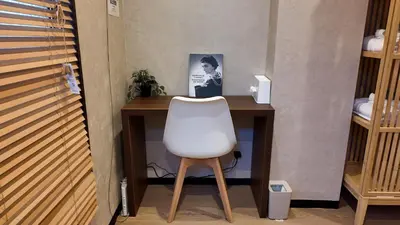 a white chair sitting in front of a desk at KYOSAI-Asakusa Q in Tokyo