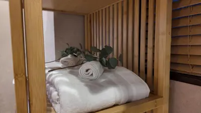 a room with a bed with towels on it at KYOSAI-Asakusa Q in Tokyo