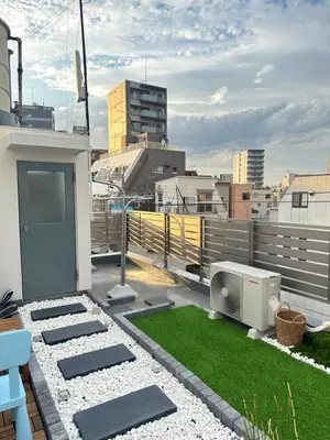 a rooftop patio with grass on a building at KYOSAI-Asakusa Q in Tokyo