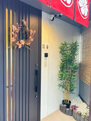 a door to a building with plants in front of it at KYOSAI-Asakusa Q in Tokyo