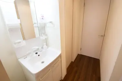 a bathroom with a white sink and a mirror at Chill Place 125 Kameari in Tokyo