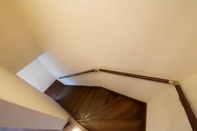 a stairwell in a house with a wooden door at Chill Place 125 Kameari in Tokyo
