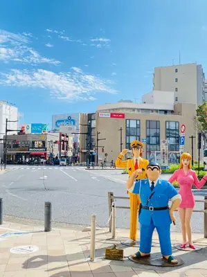 a group of people dressed in costumes standing on a street at Chill Place 125 Kameari in Tokyo