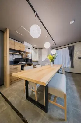 a kitchen and dining room with a wooden table and chairs at Mitsuki in Tokyo