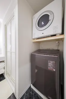 a microwave sitting on top of a washer and dryer at Mitsuki in Tokyo