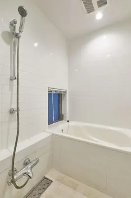 a white bathroom with a tub and a shower at Mint House Ebisu - 3 Story, Artsy & Modern Home in Shibuya in Tokyo