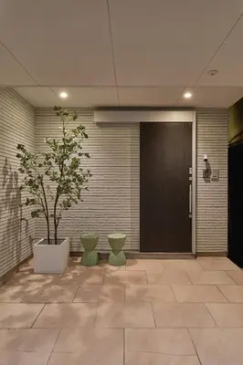 a hallway with a door and a potted plant at Mint House Ebisu - 3 Story, Artsy & Modern Home in Shibuya in Tokyo