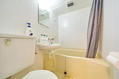 a bathroom with a sink and a toilet and a tub at 11 Under the Moon Shin-Okubo Station 3 minute walk in Tokyo