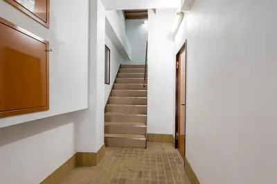 a hallway with stairs in a building at Blue Sky 3F in Tokyo