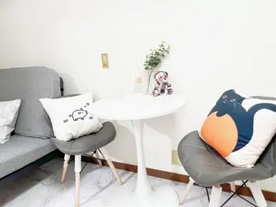 a living room with a couch and a table and chairs at \u6c60\u888b\u99c5\u96fb\u8eca4\u5206 2LDK a2 in Tokyo