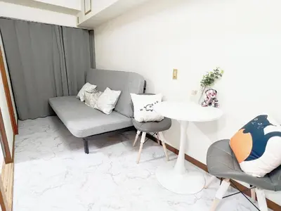 a living room with a couch and a table at \u6c60\u888b\u99c5\u96fb\u8eca4\u5206 2LDK a2 in Tokyo